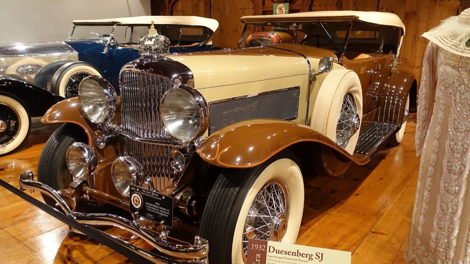 Tan and brown 1932 Duesenberg Model SJ LaGrande dual-cowl phaeton, front-left three-quarter view
