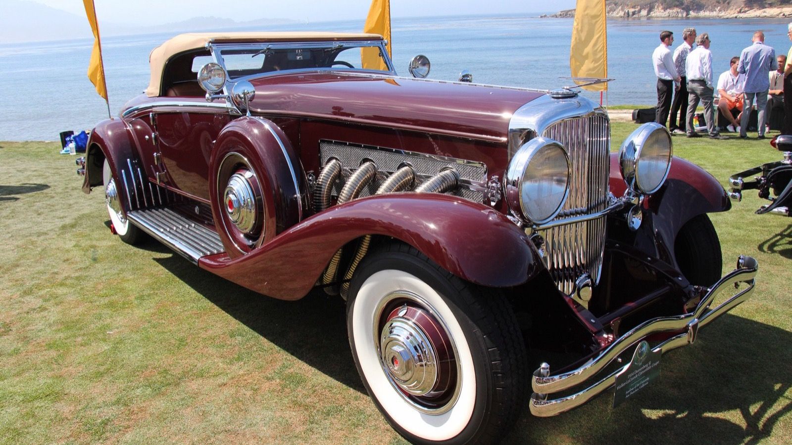 Maroon 1934 Duesenberg SJ convertible coupe, front-right three-quarter view