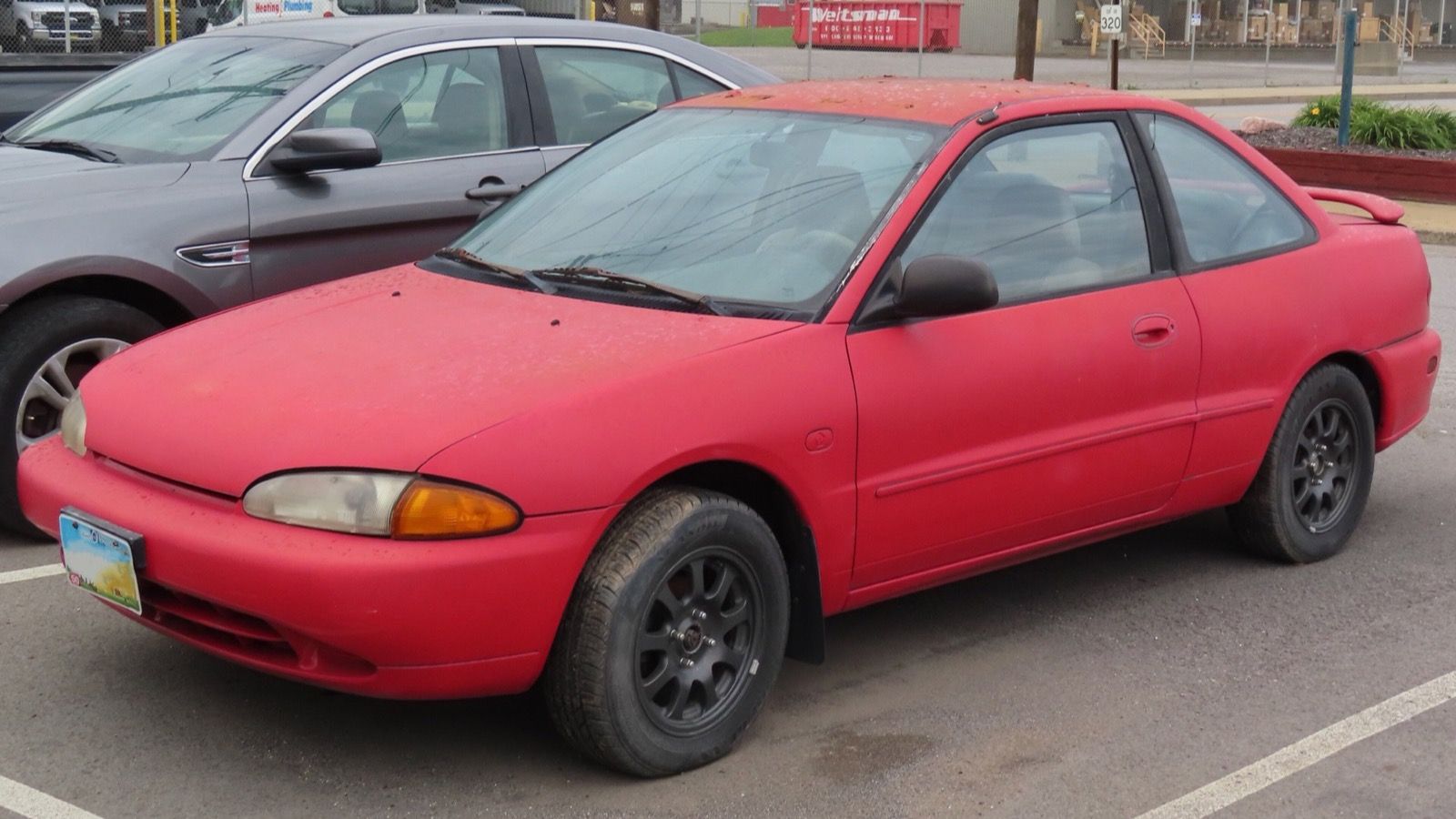 Red 1994 Eagle Summit ES two-door coupe, front three-quarter view.