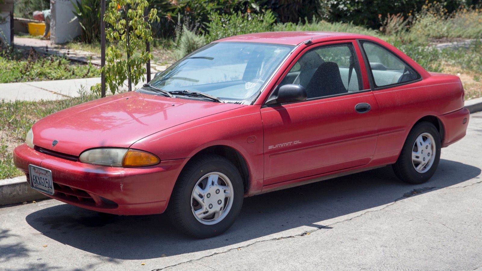 Red 1995 Eagle Summit DL two-door coupe, front three-quarter view.