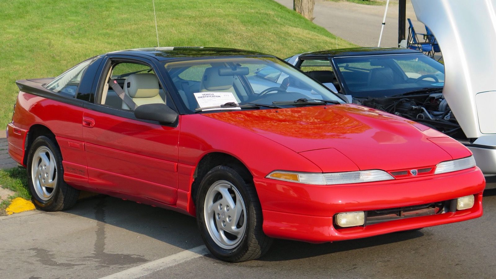 Red 1991 Eagle Talon TSi AWD, front three-quarter view, with its pop-up headlights retracted.