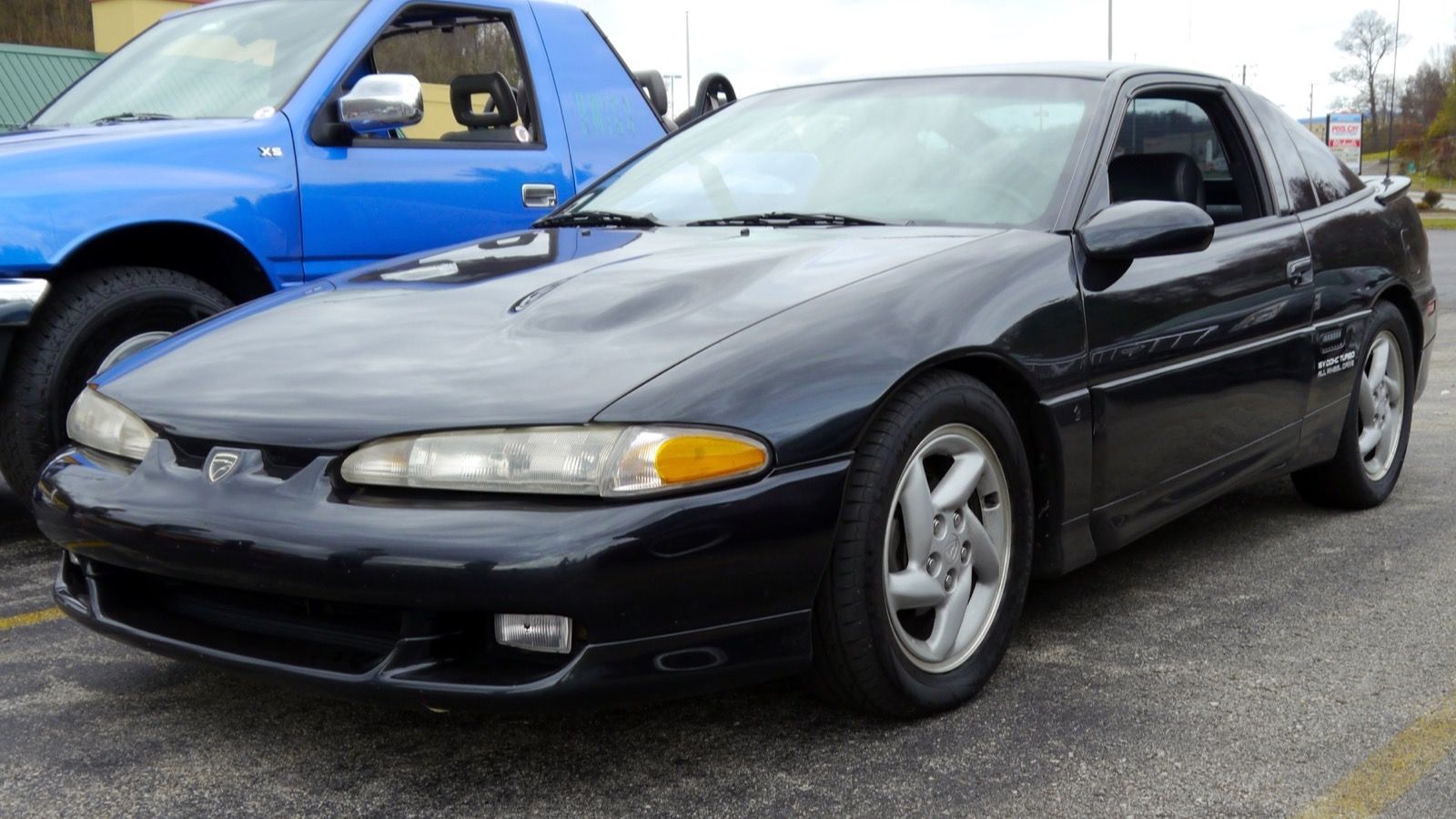 Black 1992 Eagle Talon TSi AWD, front three-quarter view, showing the fixed composite headlights of the 1GB facelift.