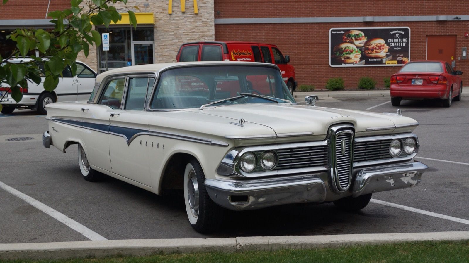 White 1959 Edsel Ranger four-door sedan, front three-quarter view showing the toned-down grille