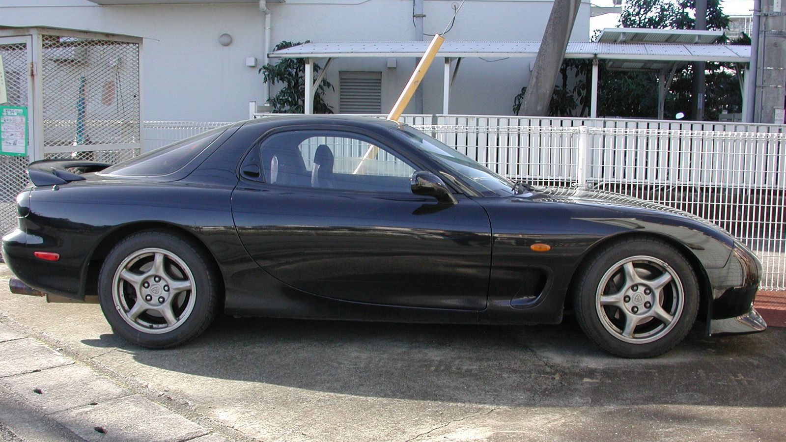 Black 1991 ɛ̃fini RX-7 Type R (E-FD3S), side profile parked on a Japanese street