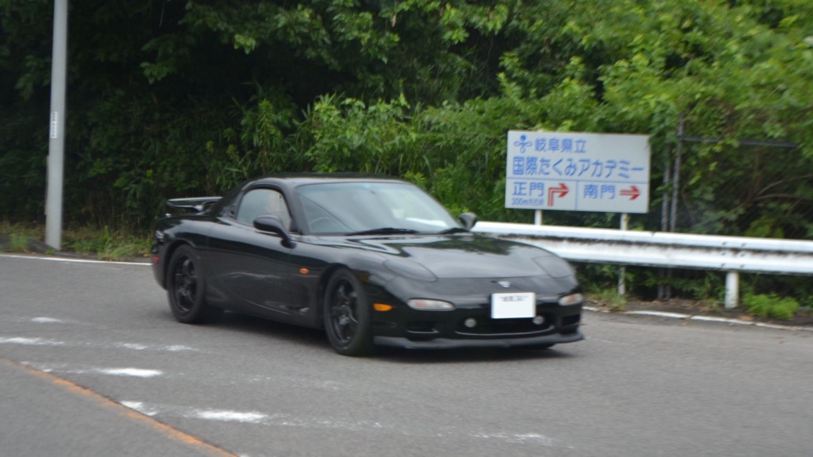Black 1995 ɛ̃fini RX-7 Type R-S (E-FD3S) on a rural road, front three-quarter view