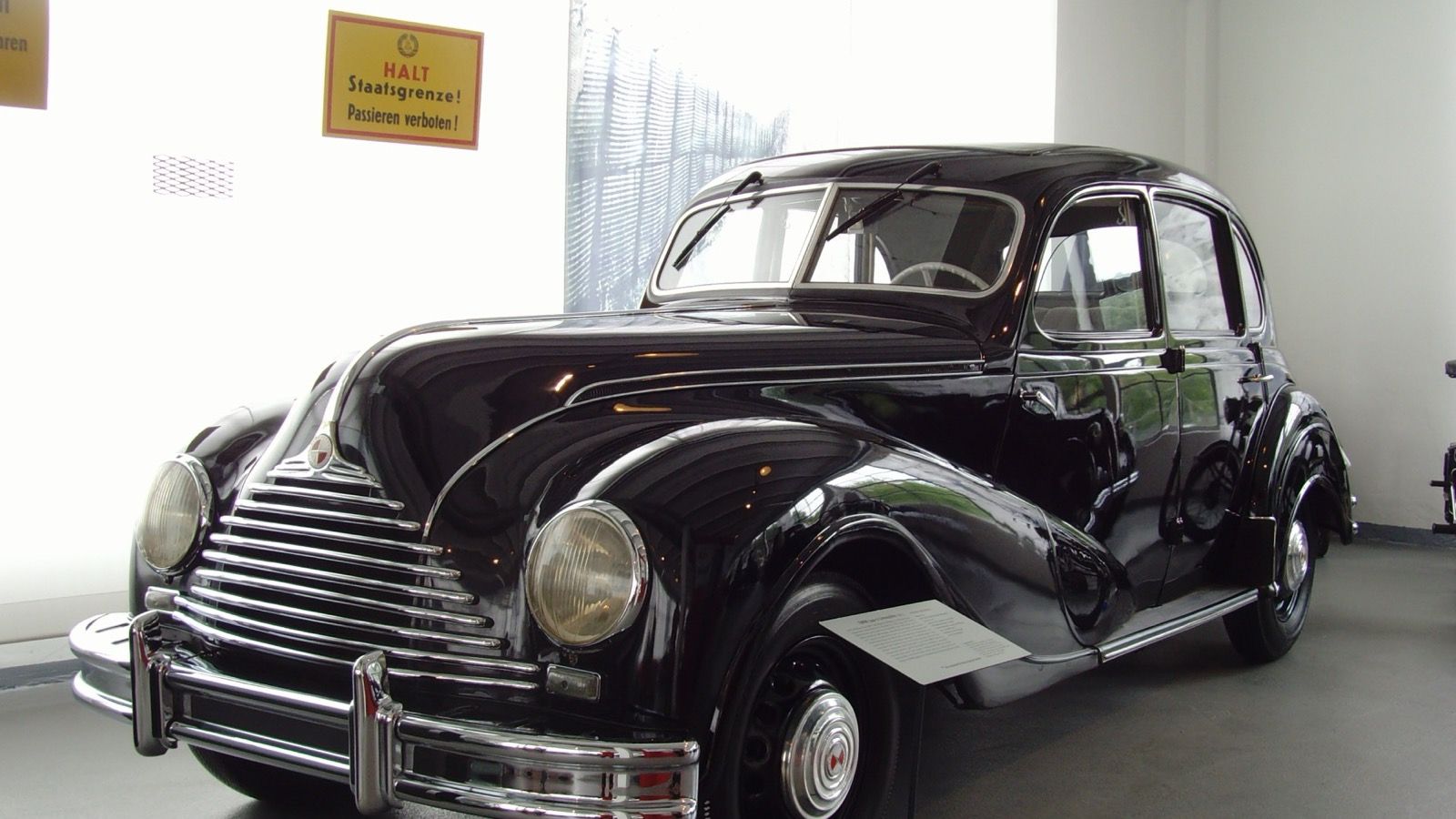 Black 1953 EMW 340-2 four-door saloon on museum display, front three-quarter view