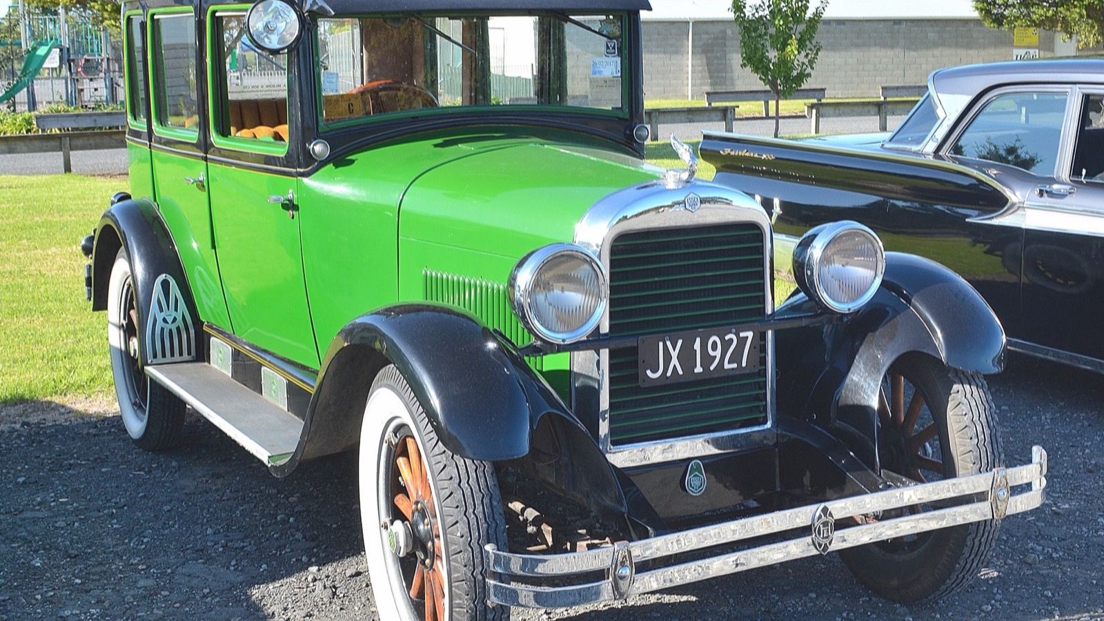 Green and black 1927 Essex Super Six sedan parked on gravel, front three-quarter view