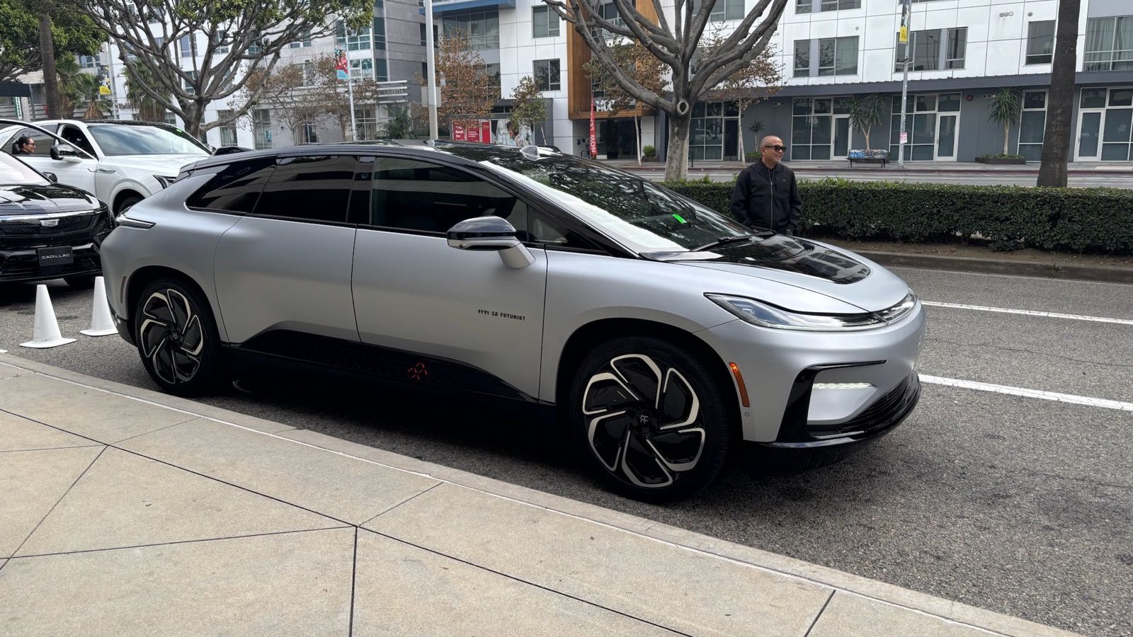 Silver Faraday Future FF 91 2.0 Futurist production crossover, front three-quarter view on a city street