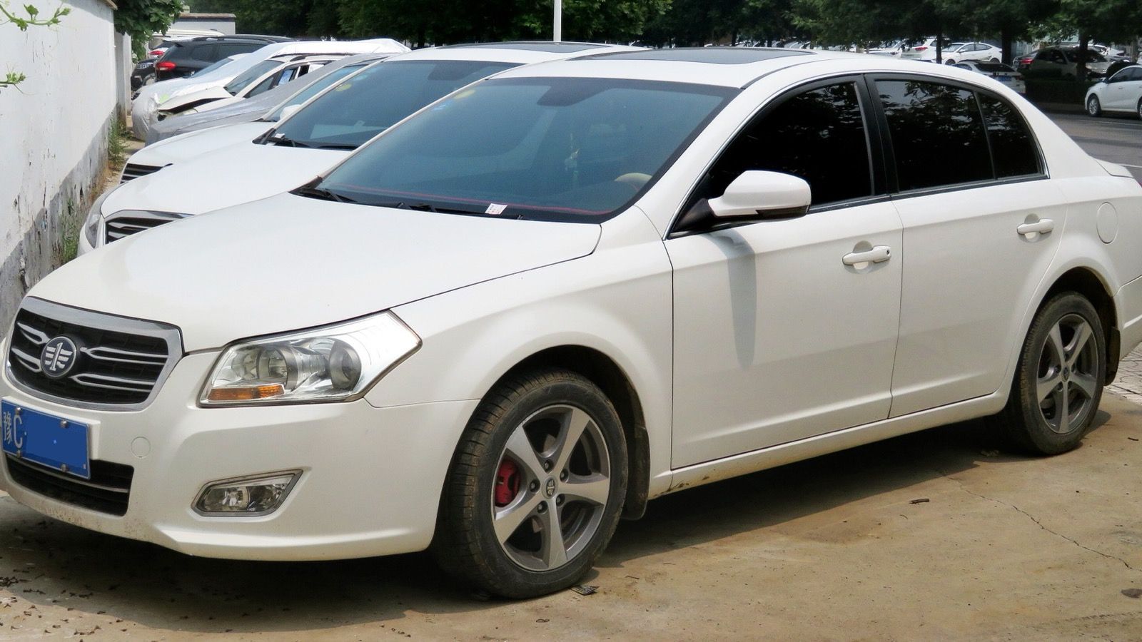 2013 FAW Besturn B70 facelift sedan in white, front three-quarter view