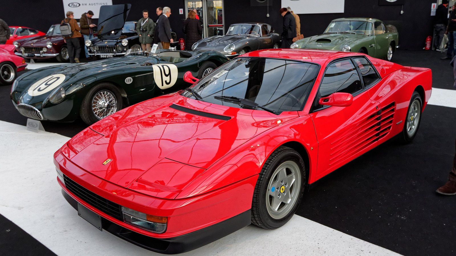 Red Ferrari Testarossa showing its side strakes, front three-quarter view