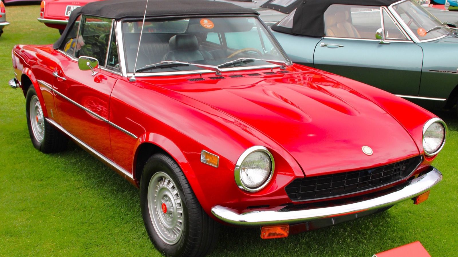 Red 1976 Fiat 124 Sport Spider with the top up, front three-quarter view