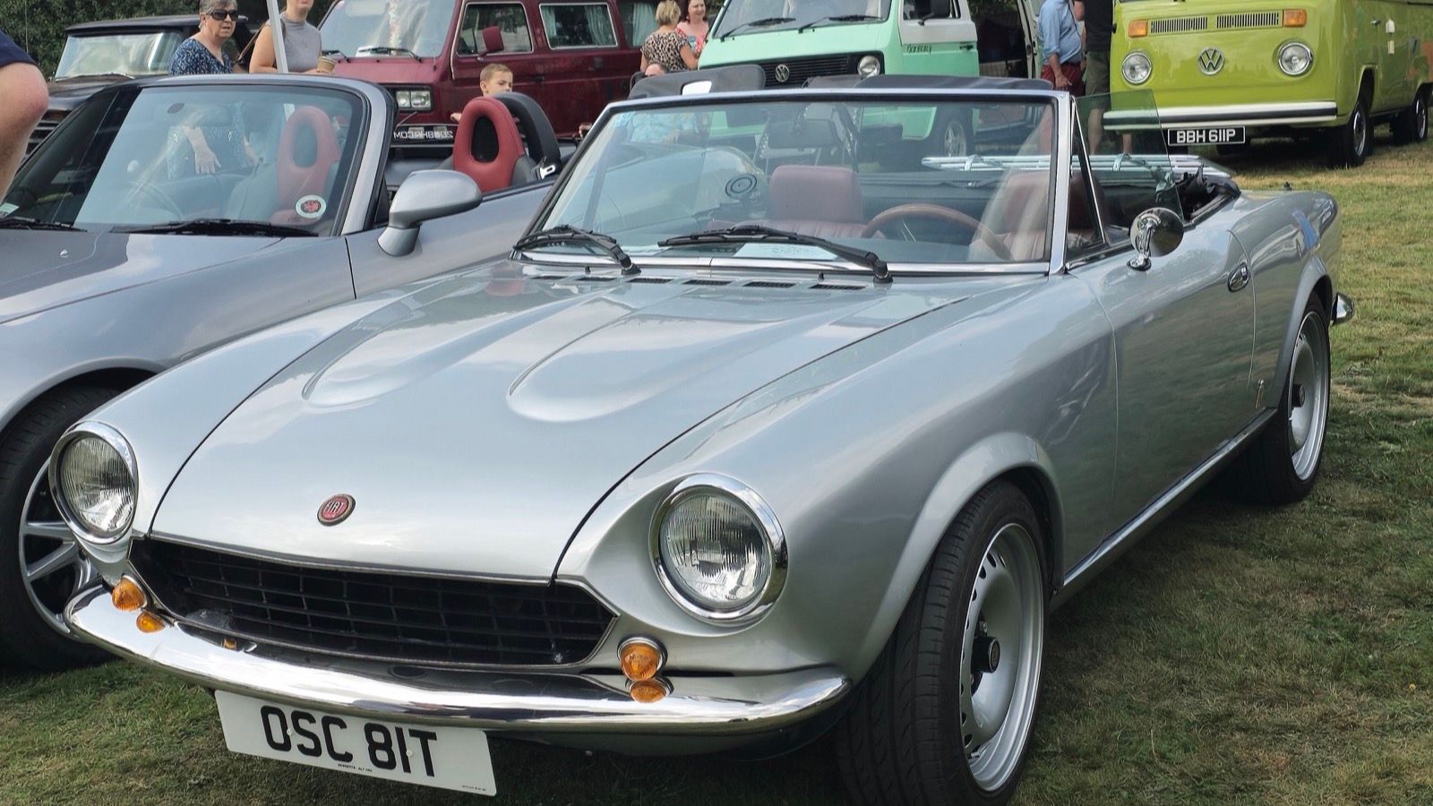 Silver 1979 Fiat 124 Spider with the top down, front three-quarter view