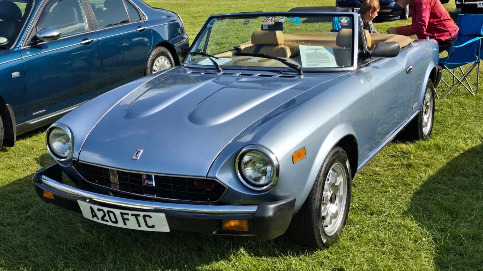 Light blue 1984 Fiat 124 Sport Spider with Pininfarina badging, front three-quarter view