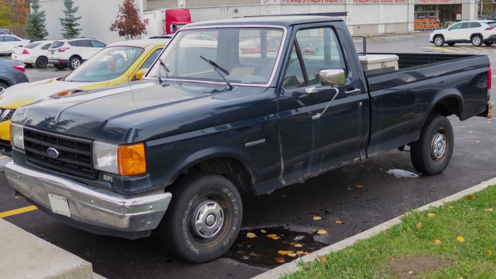 1988 Ford F-150 blue custom pickup truck, front three-quarter left view