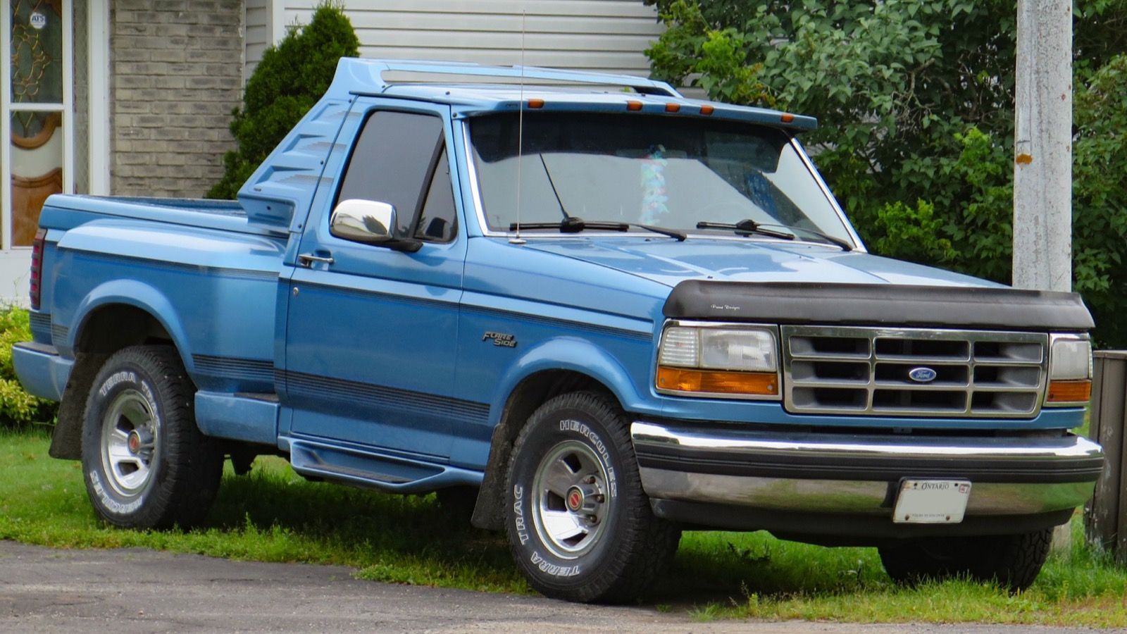 1992 Ford F-150 blue xlt pickup truck, front three-quarter right view