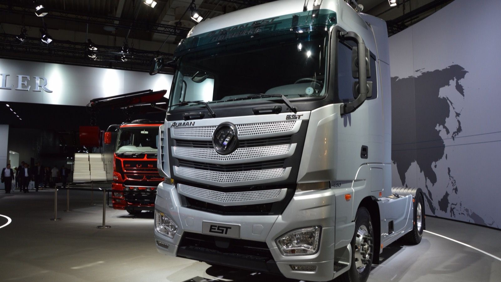 Silver Foton Auman EST heavy tractor unit on show stand, front three-quarter view