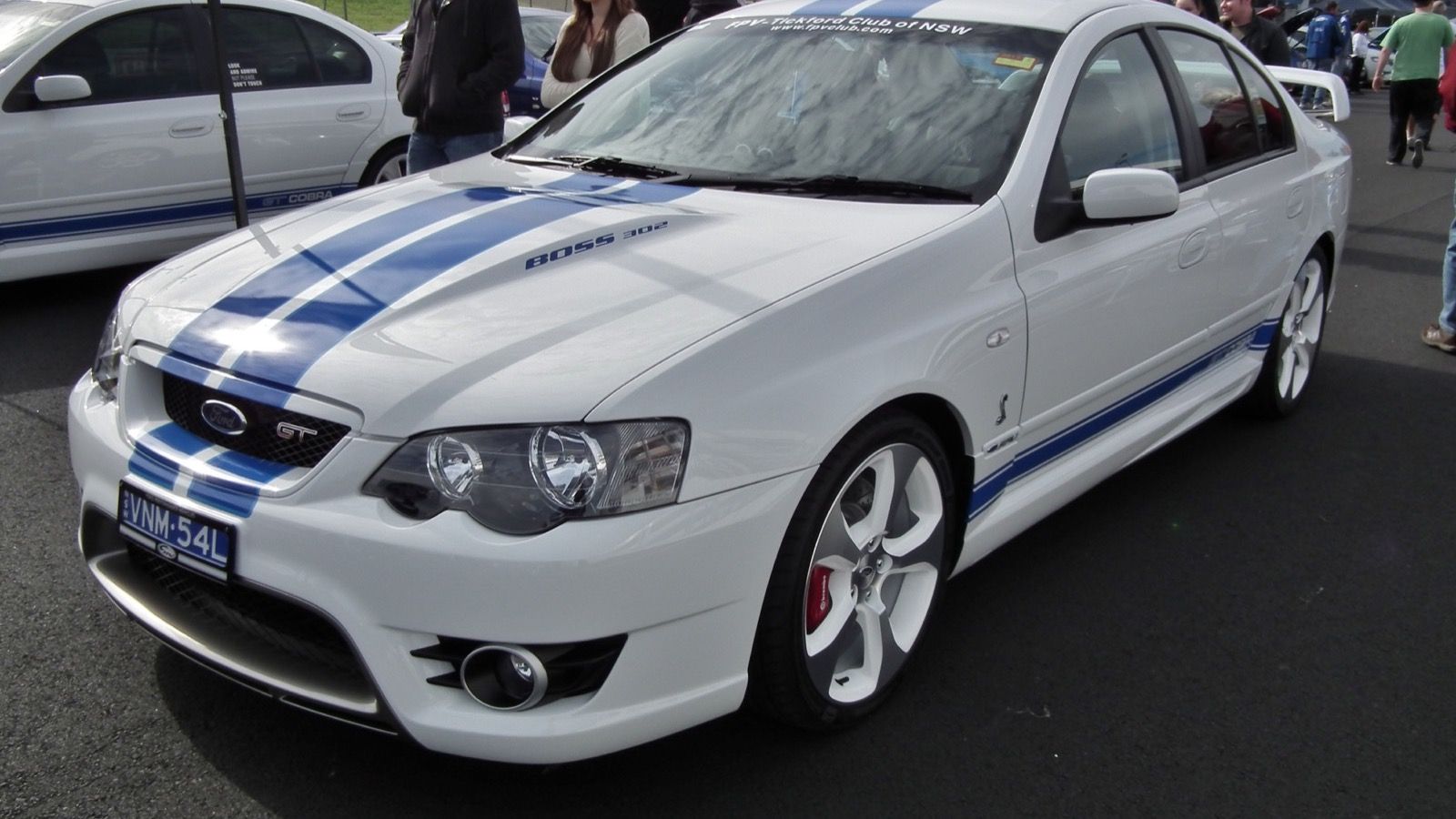 White 2007 FPV GT Cobra (BF Falcon) sedan with blue stripes, front three-quarter view