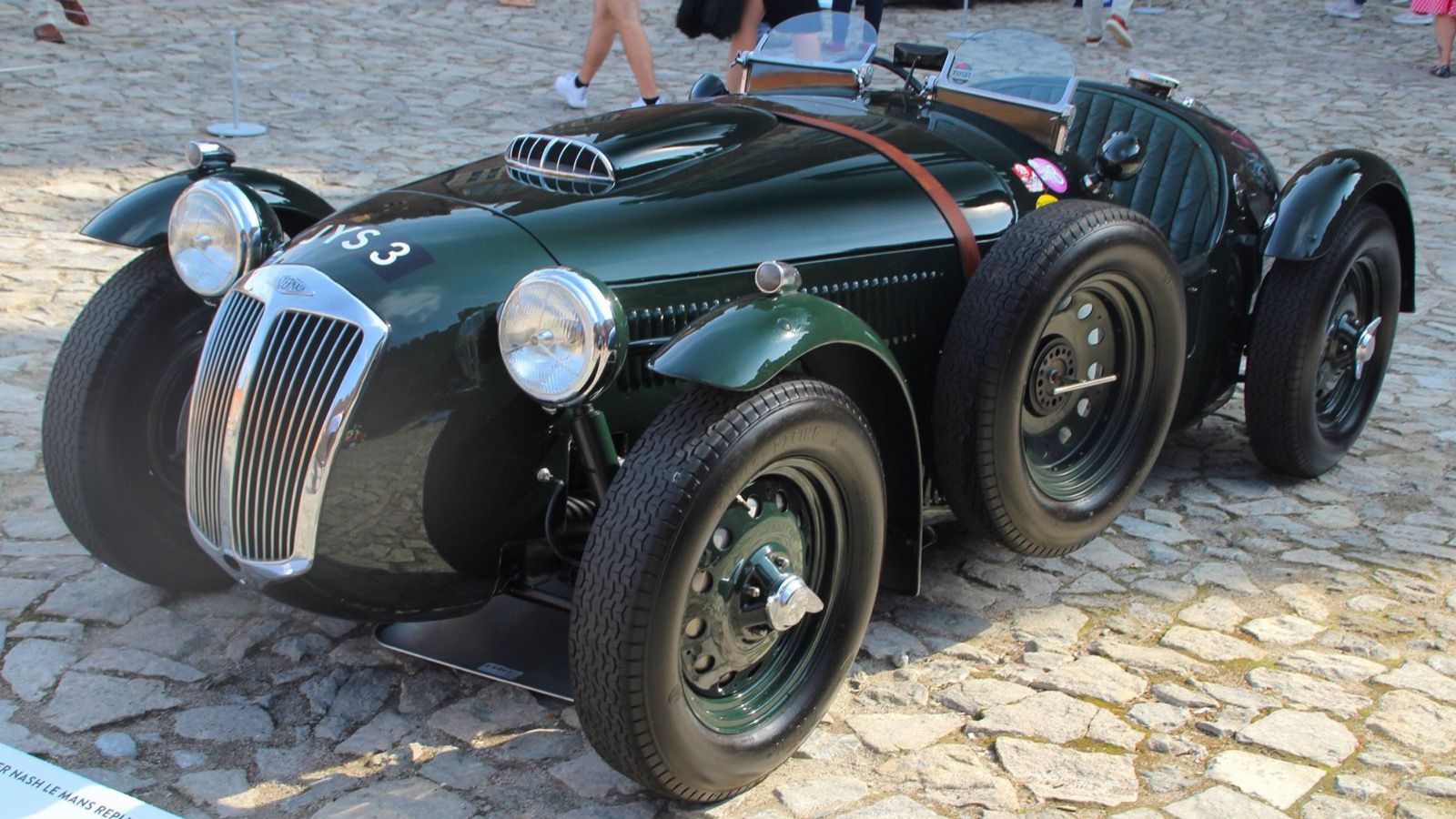 Green 1952 Frazer Nash Le Mans Replica open roadster on cobblestones, front three-quarter view