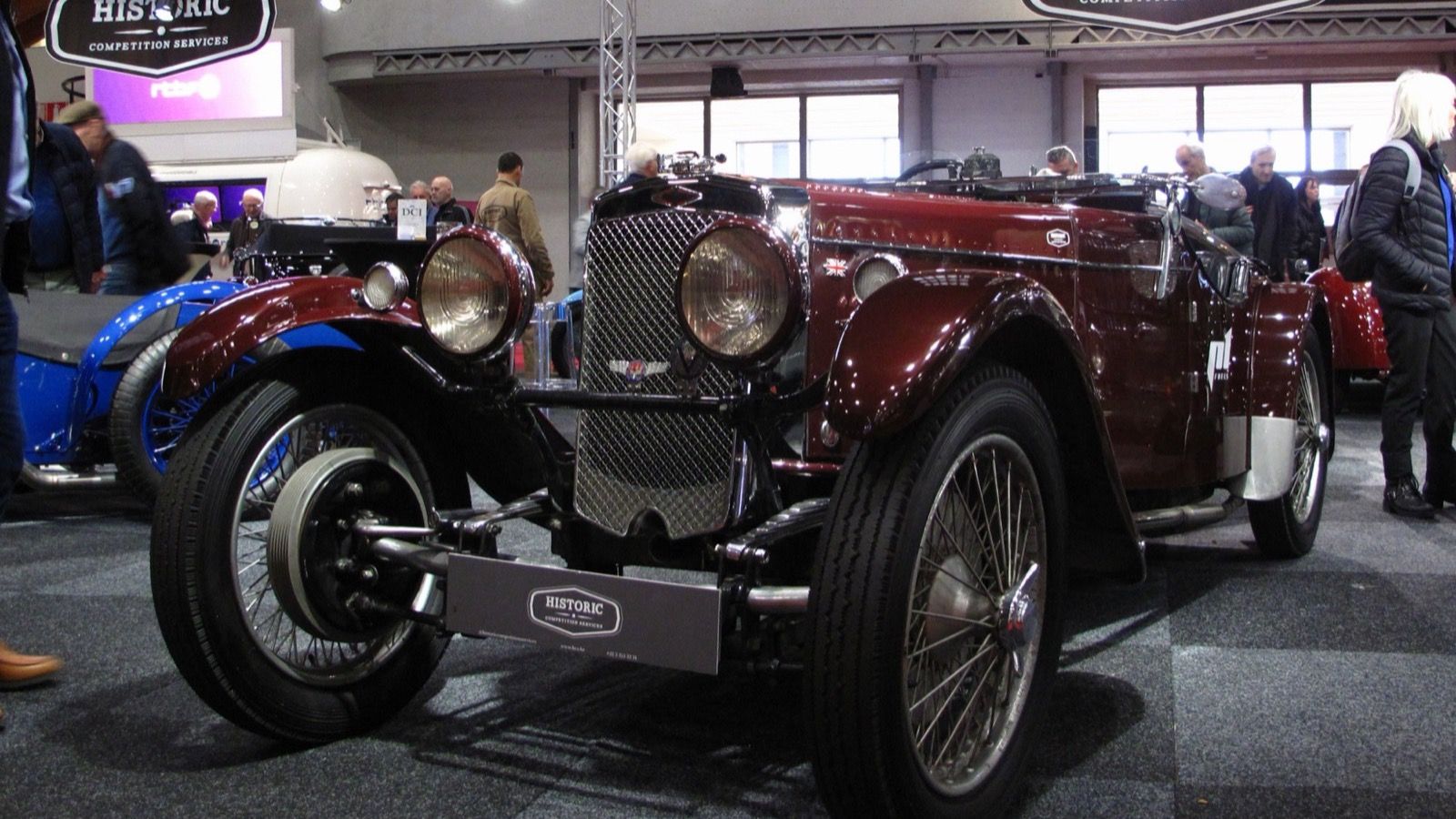 Maroon 1934 Frazer Nash TT Replica open two-seater on indoor display, front three-quarter view