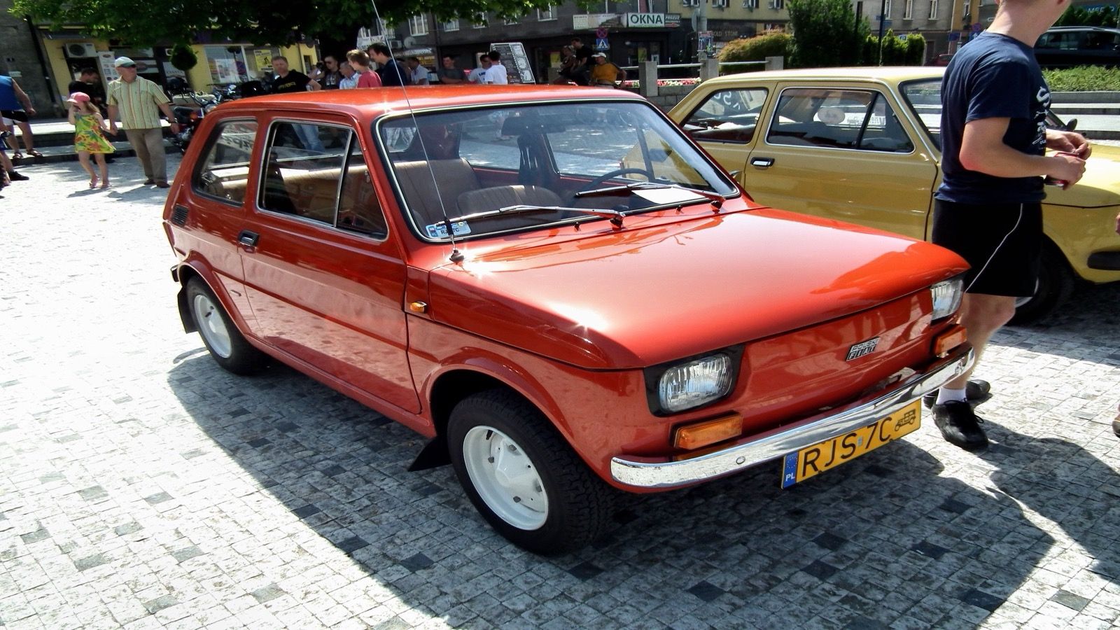 Red 1979 Polski Fiat 126p 650 at a Polish classic-car meet, front three-quarter view