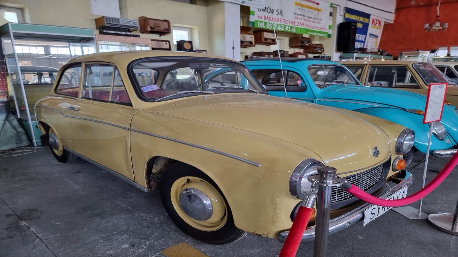 Cream FSM Syrena 105 saloon on museum display, front three-quarter view