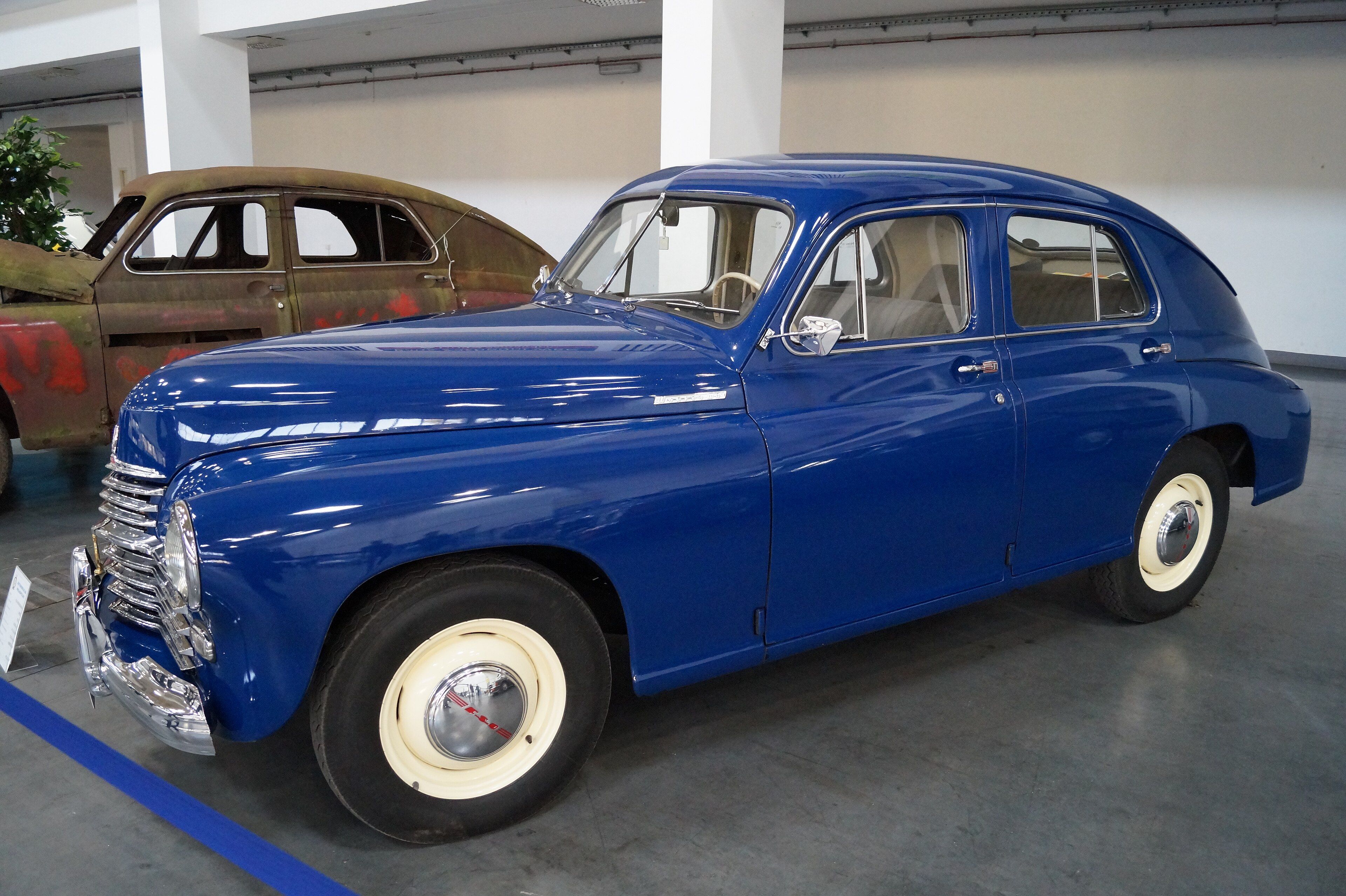 Blue FSO Warszawa M20 fastback saloon on museum display, front three-quarter view