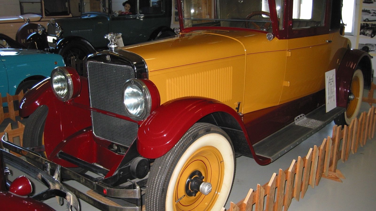 Yellow and maroon 1926 Gardner Sport Coupe on museum display, front three-quarter view