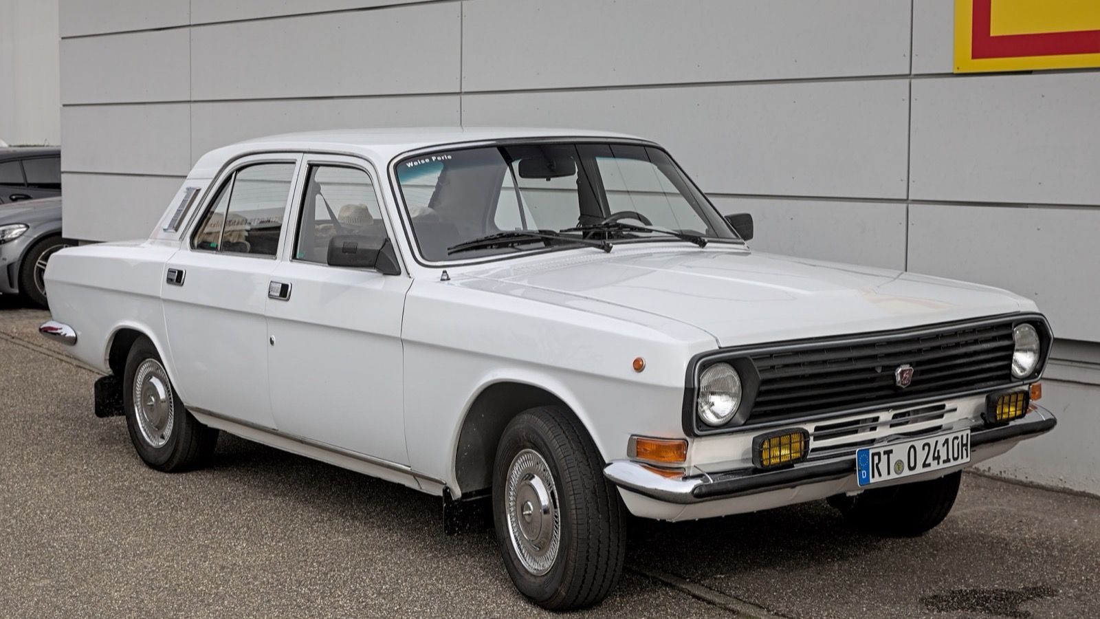 White 1979 GAZ-24 Volga four-door saloon parked outdoors, front three-quarter view