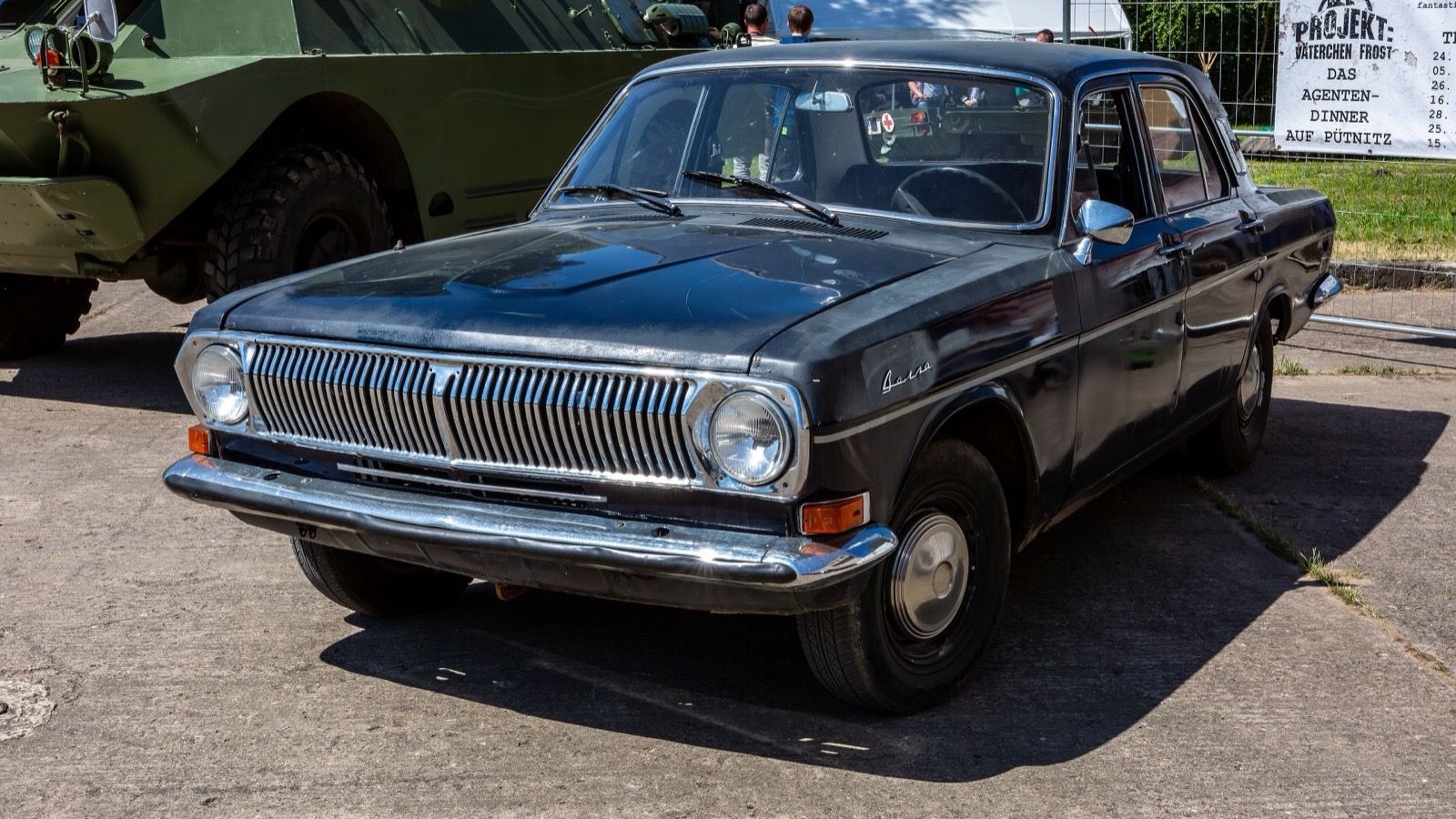 Dark blue GAZ-24 Volga saloon at a vehicle meet, front three-quarter view