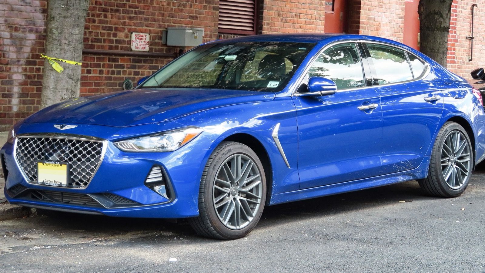 Blue first-generation Genesis G70 2.0T, front three-quarter view