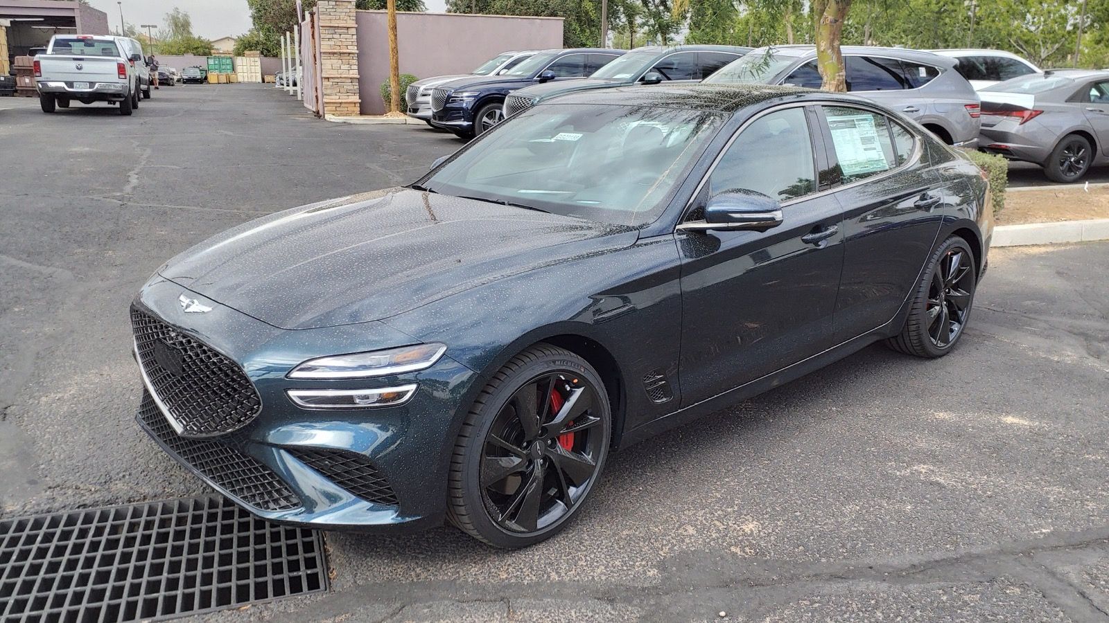Dark teal 2023 Genesis G70 3.3T, front three-quarter view