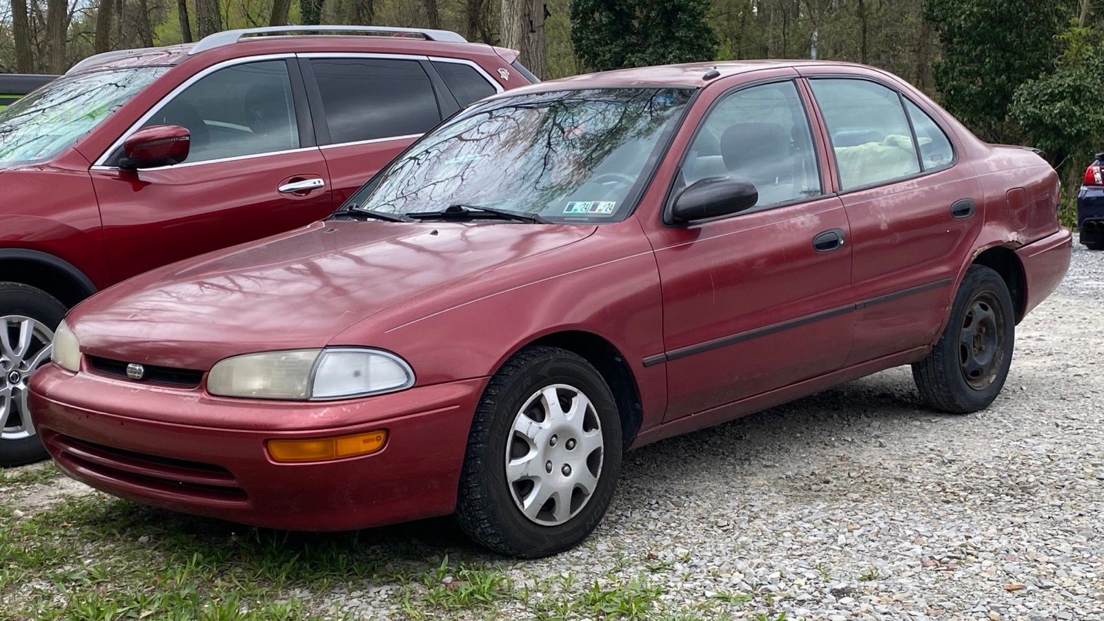 Crimson 1996 Geo Prizm LSi sedan, front three-quarter view