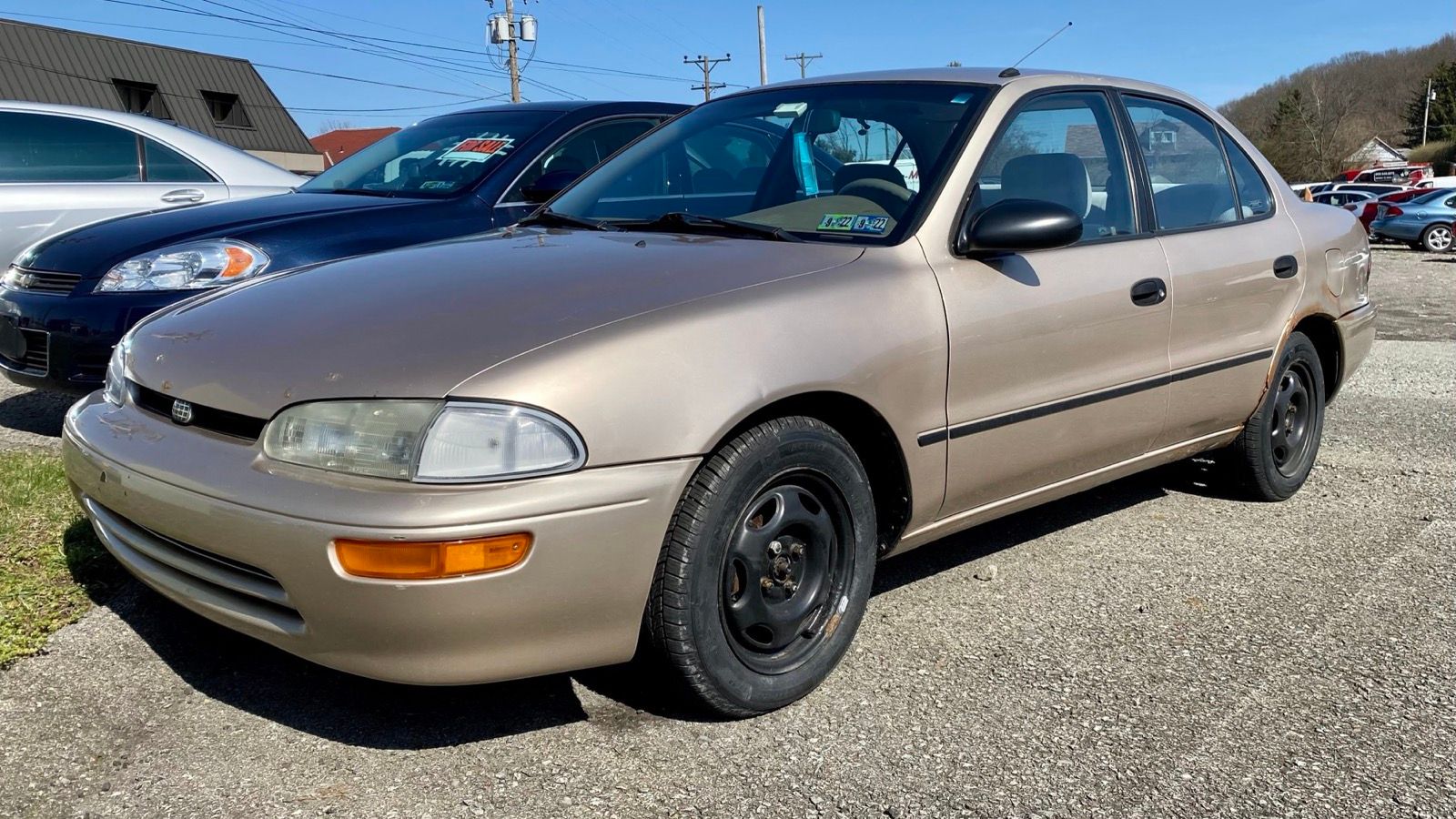 Desert sand 1997 Geo Prizm LSi sedan, front three-quarter view
