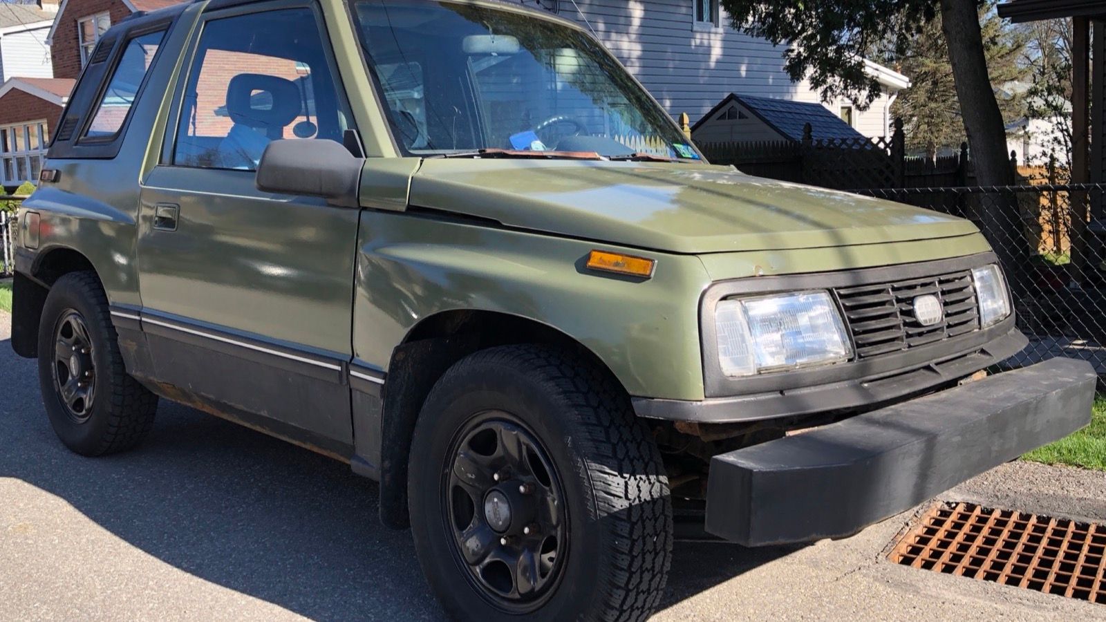 Green 1992 Geo Tracker 4x4 two-door, front three-quarter view