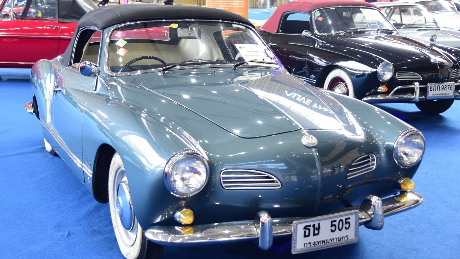 Grey-blue 1963 Volkswagen Karmann Ghia Type 14 cabriolet with the soft top raised, front three-quarter view.