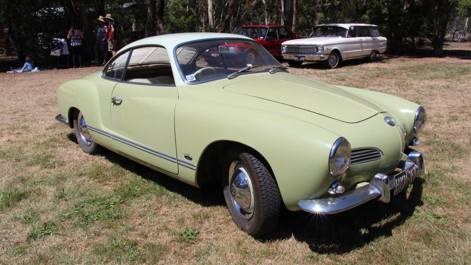 Pale green 1965 Volkswagen Karmann Ghia Type 14 coupé, front three-quarter view.
