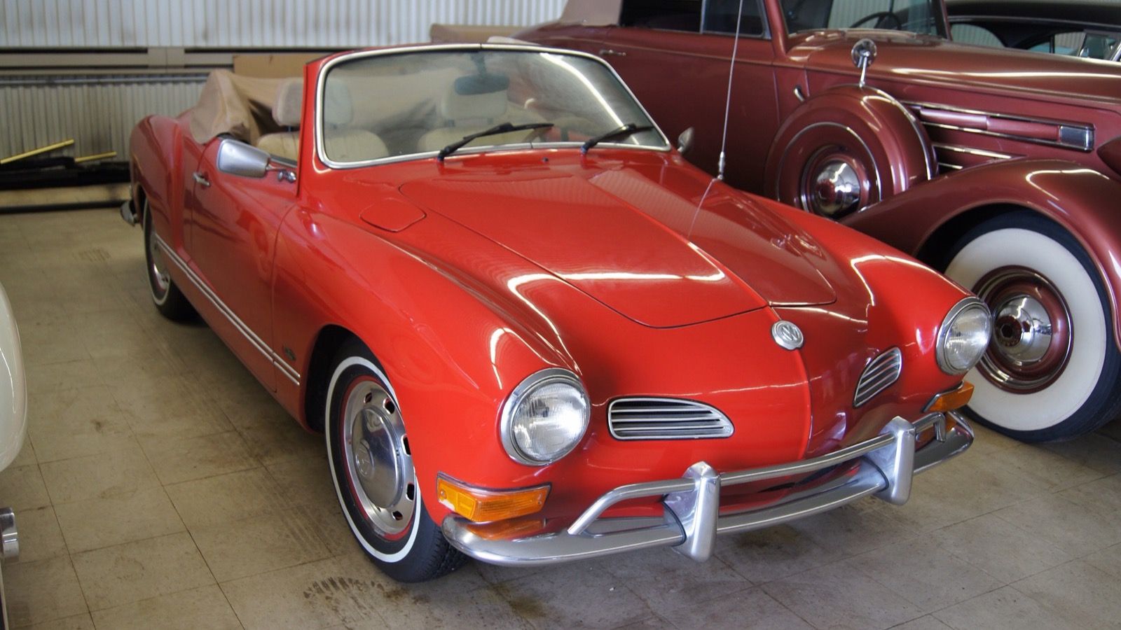 Red 1971 Volkswagen Karmann Ghia cabriolet with the top folded down, front three-quarter view.