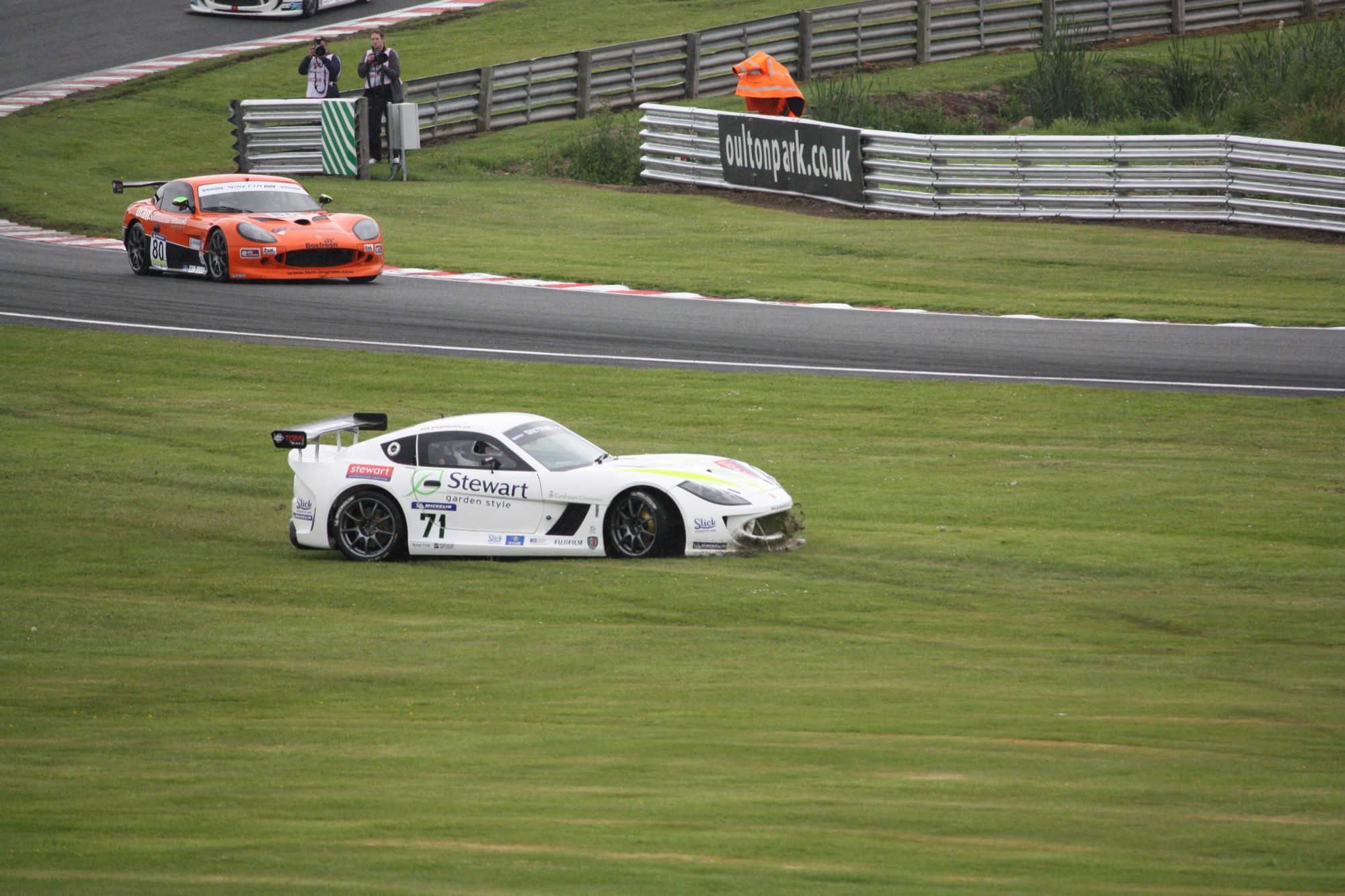 White Ginetta G55 Supercup racer in side profile on the grass at Oulton Park, 2011