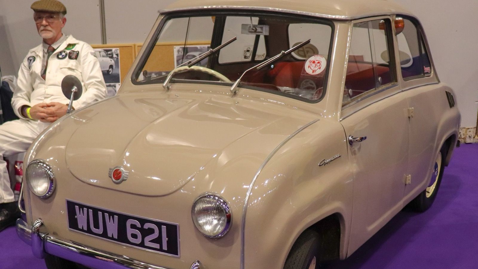 Beige 1959 Glas Goggomobil 300 sedan on an indoor display stand, front three-quarter view