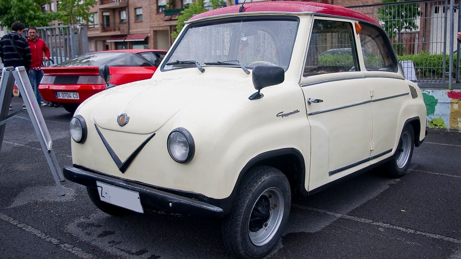 Cream 1962 Goggomobil T 250 sedan with a red roof parked outdoors, front three-quarter view