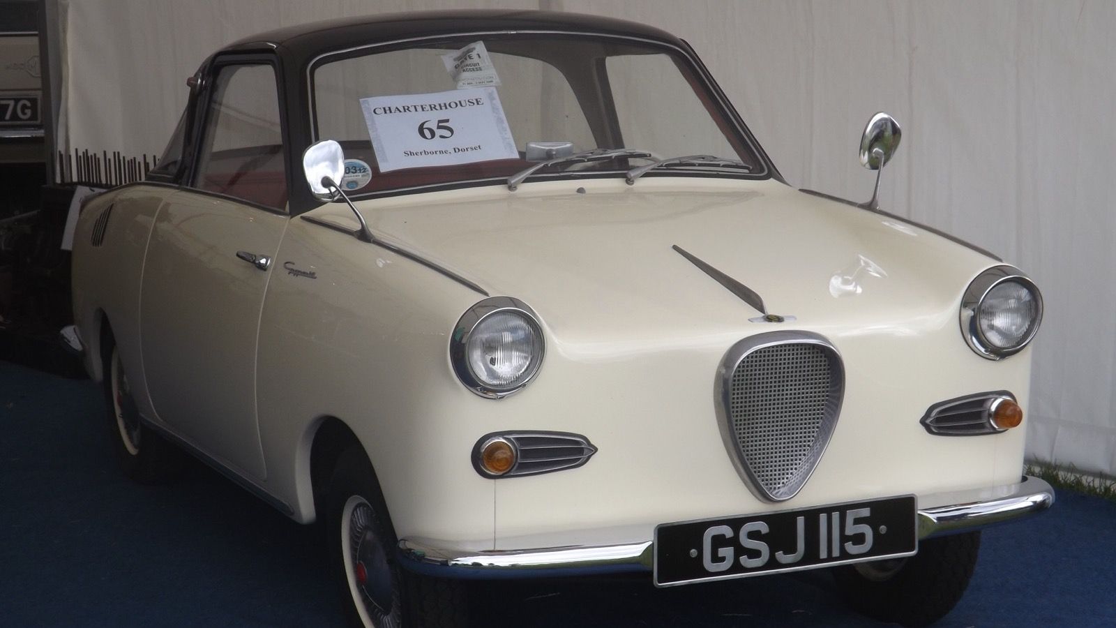 Cream 1963 Glas Goggomobil TS250 coupé with a brown roof at an auction display, front view