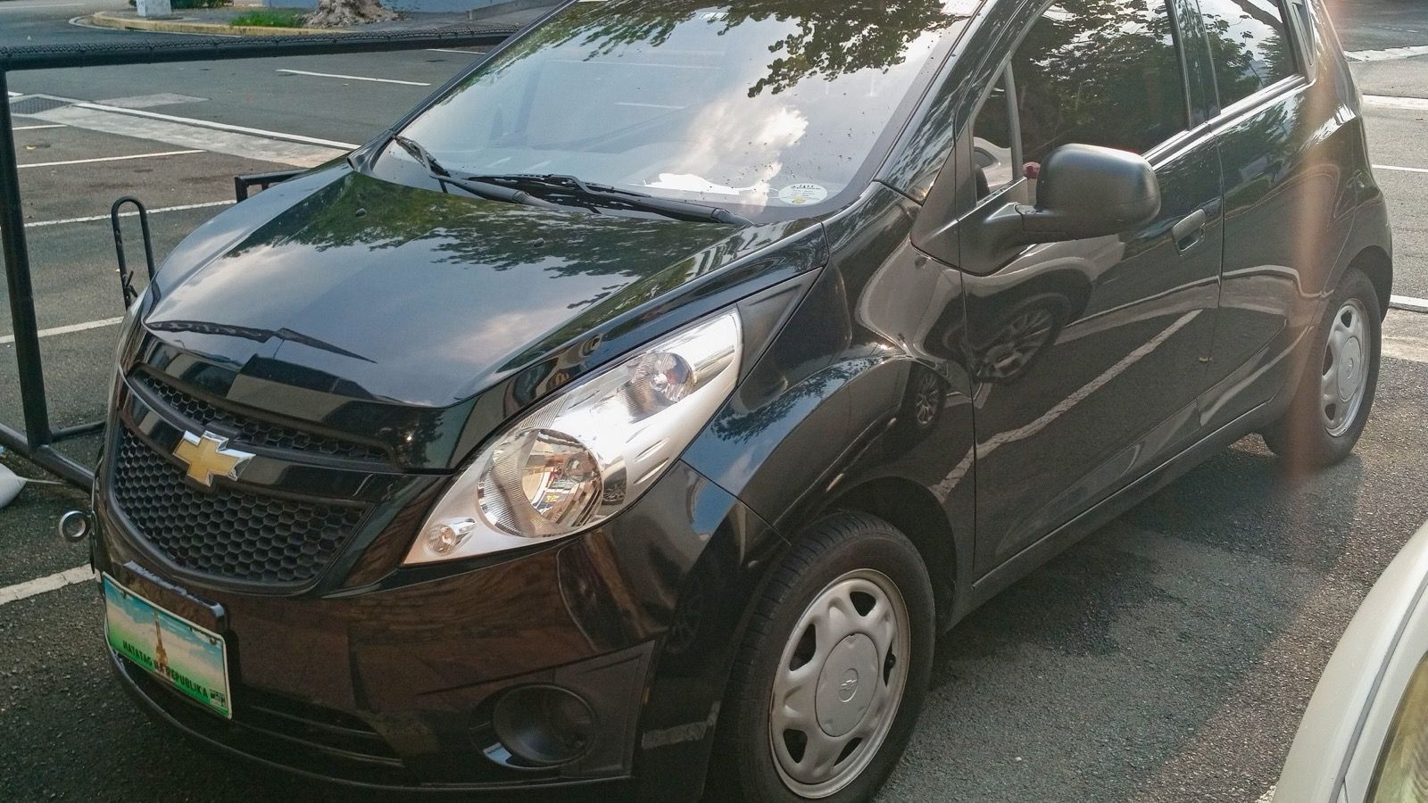 2011 Chevrolet Spark 1.0 LS hatchback, front three-quarter view from the left