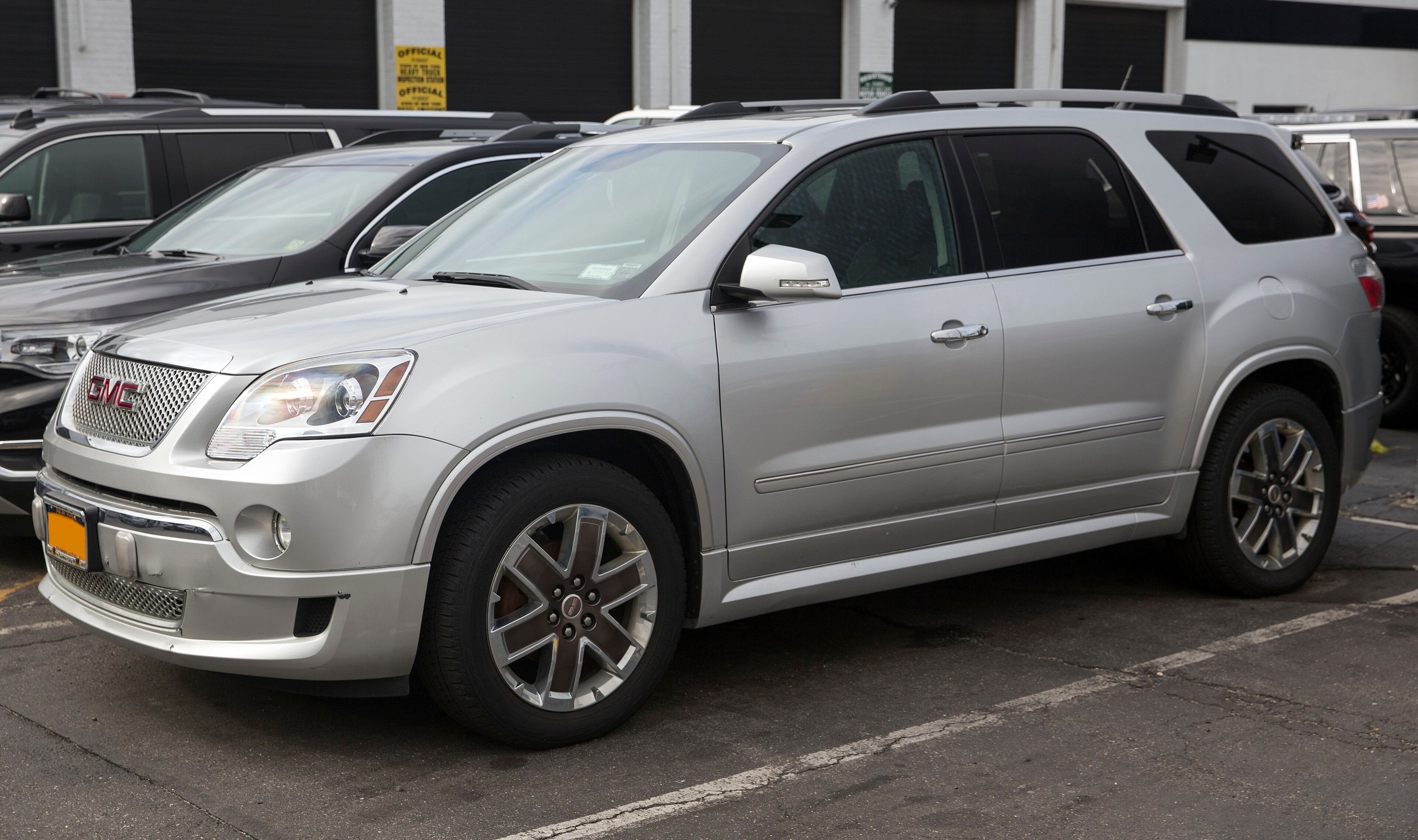 2011 GMC Acadia Denali crossover SUV in silver, front left view