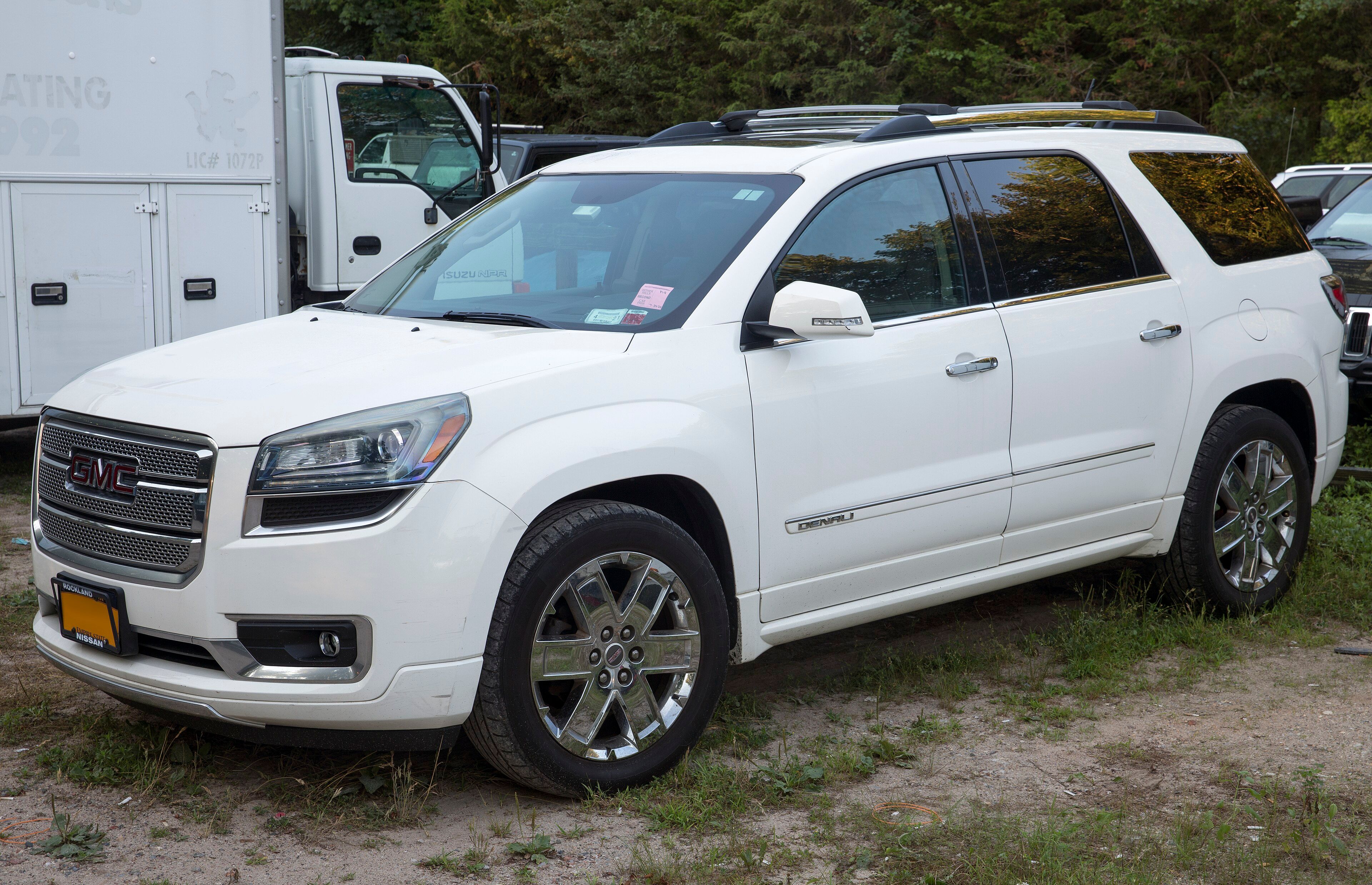 2013 GMC Acadia Denali crossover SUV, front left view