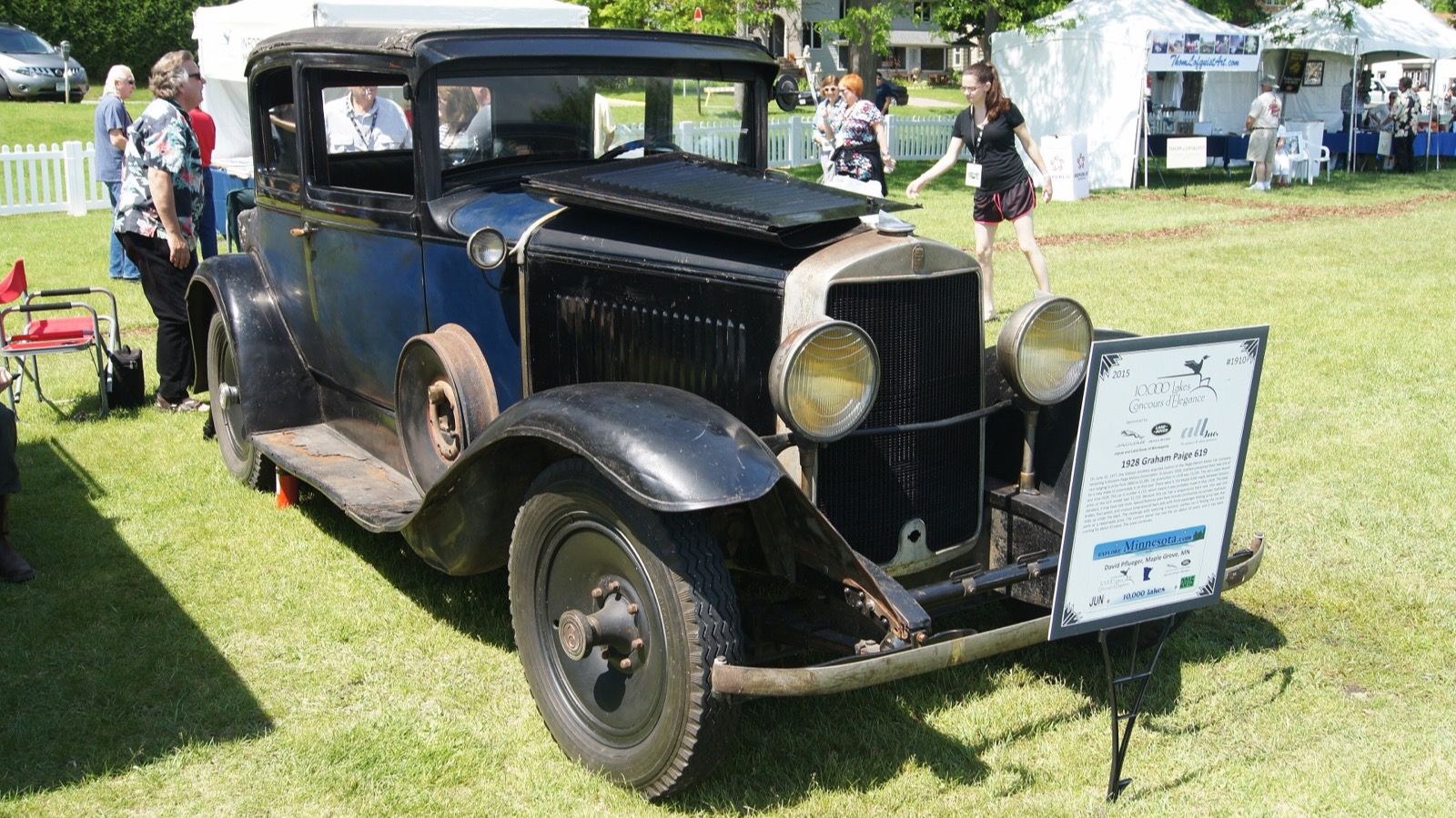 Unrestored black 1928 Graham-Paige 619 coupe on a concours lawn, front three-quarter view