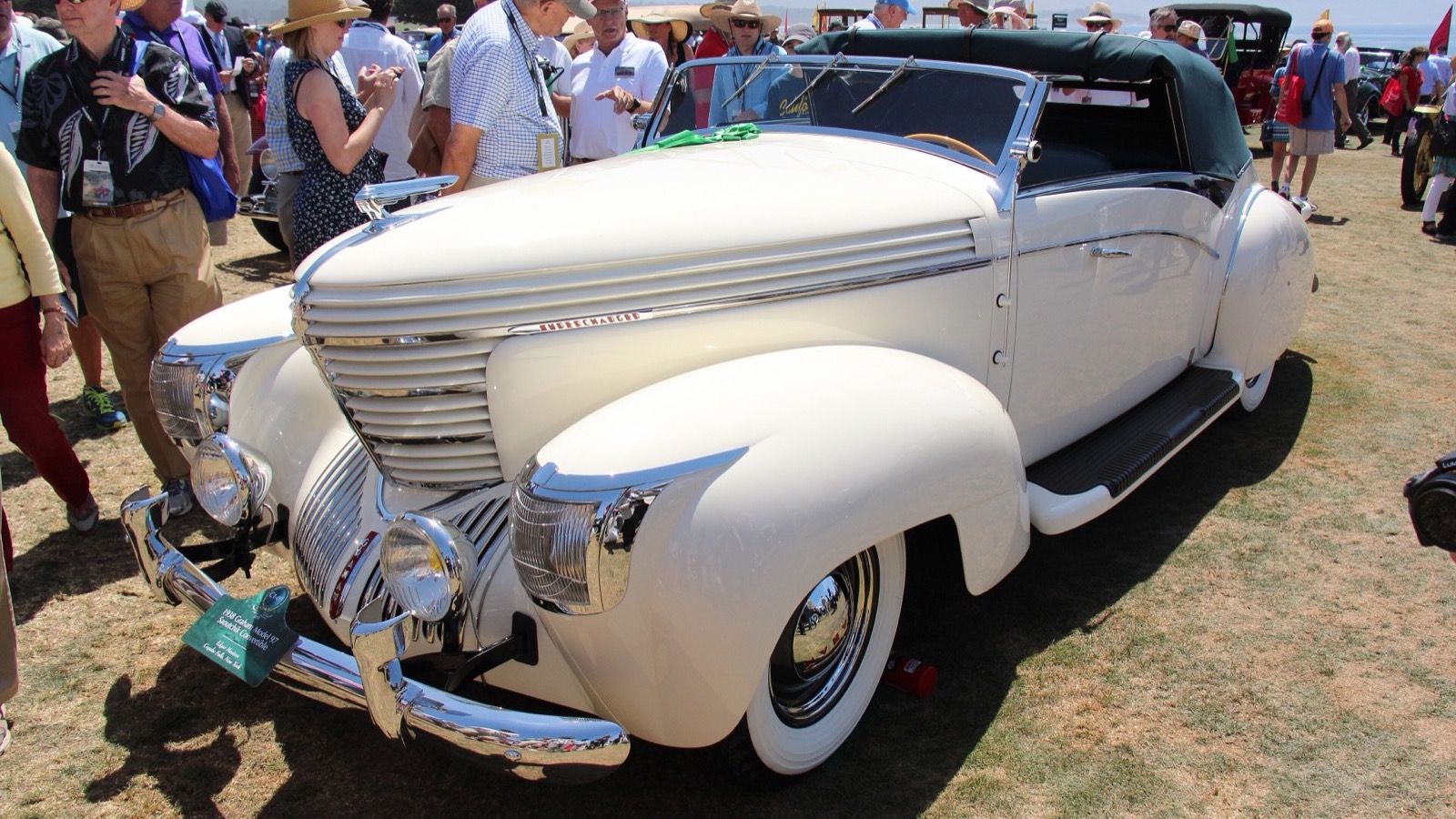 Cream 1938 Graham Model 97 Sharknose convertible at a concours, front three-quarter view
