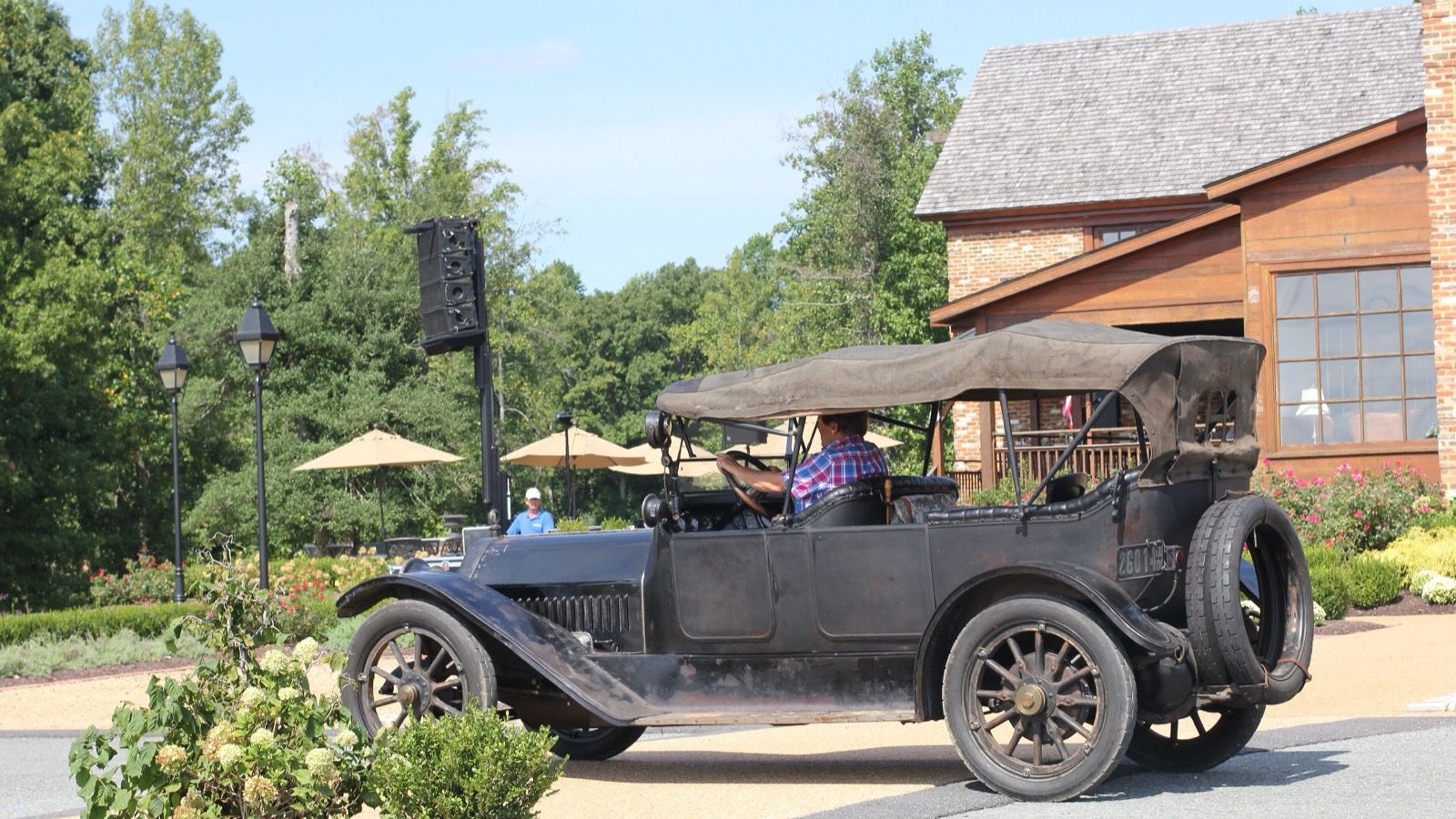 Black 1914 Haynes Model 27 touring car in side profile with its top raised.