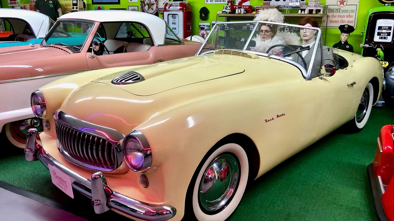 Cream 1951 Nash-Healey roadster with its original Healey body on museum display, front three-quarter view