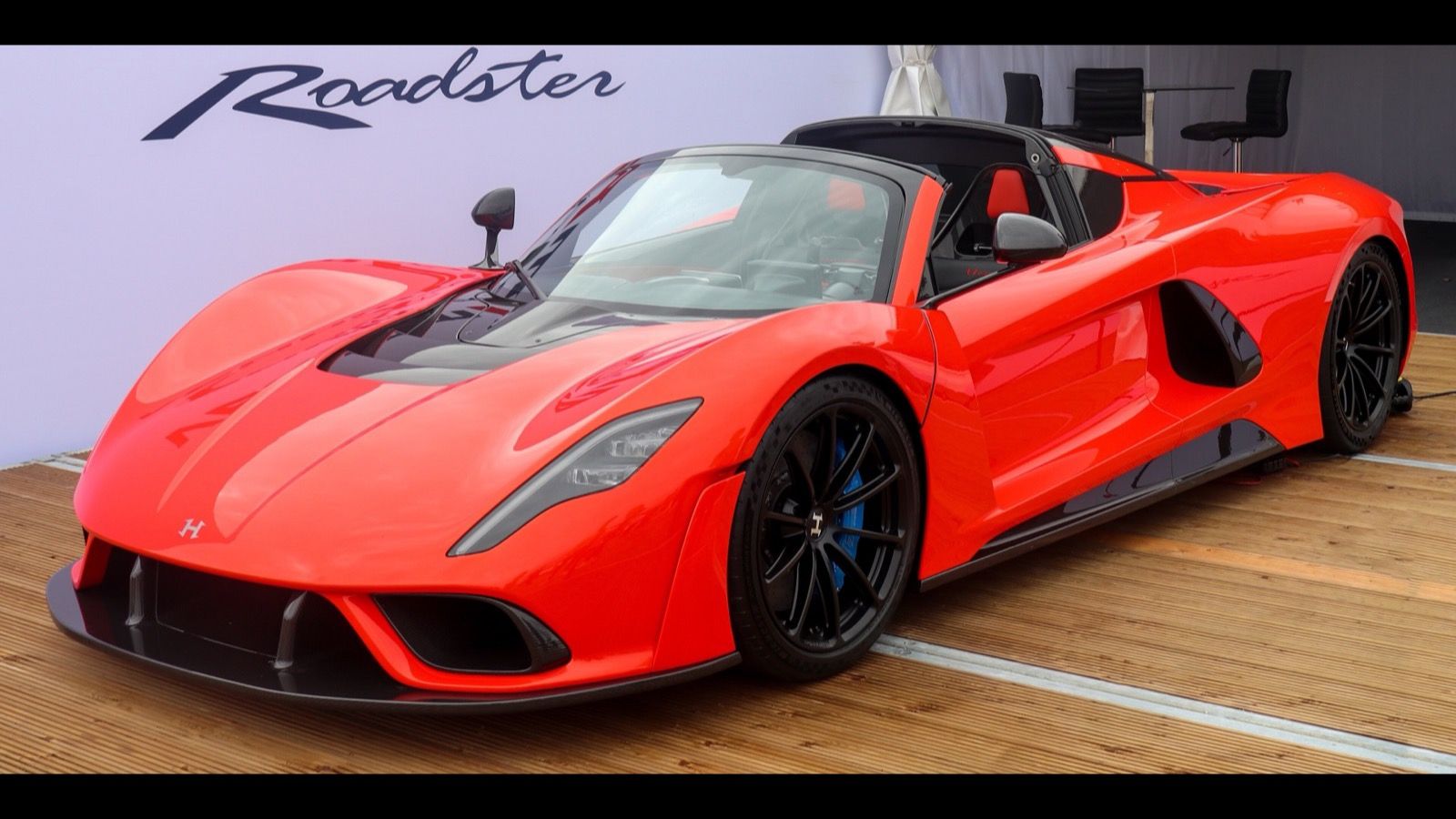 Red 2022 Hennessey Venom F5 Roadster on display with the roof panel removed, front three-quarter view