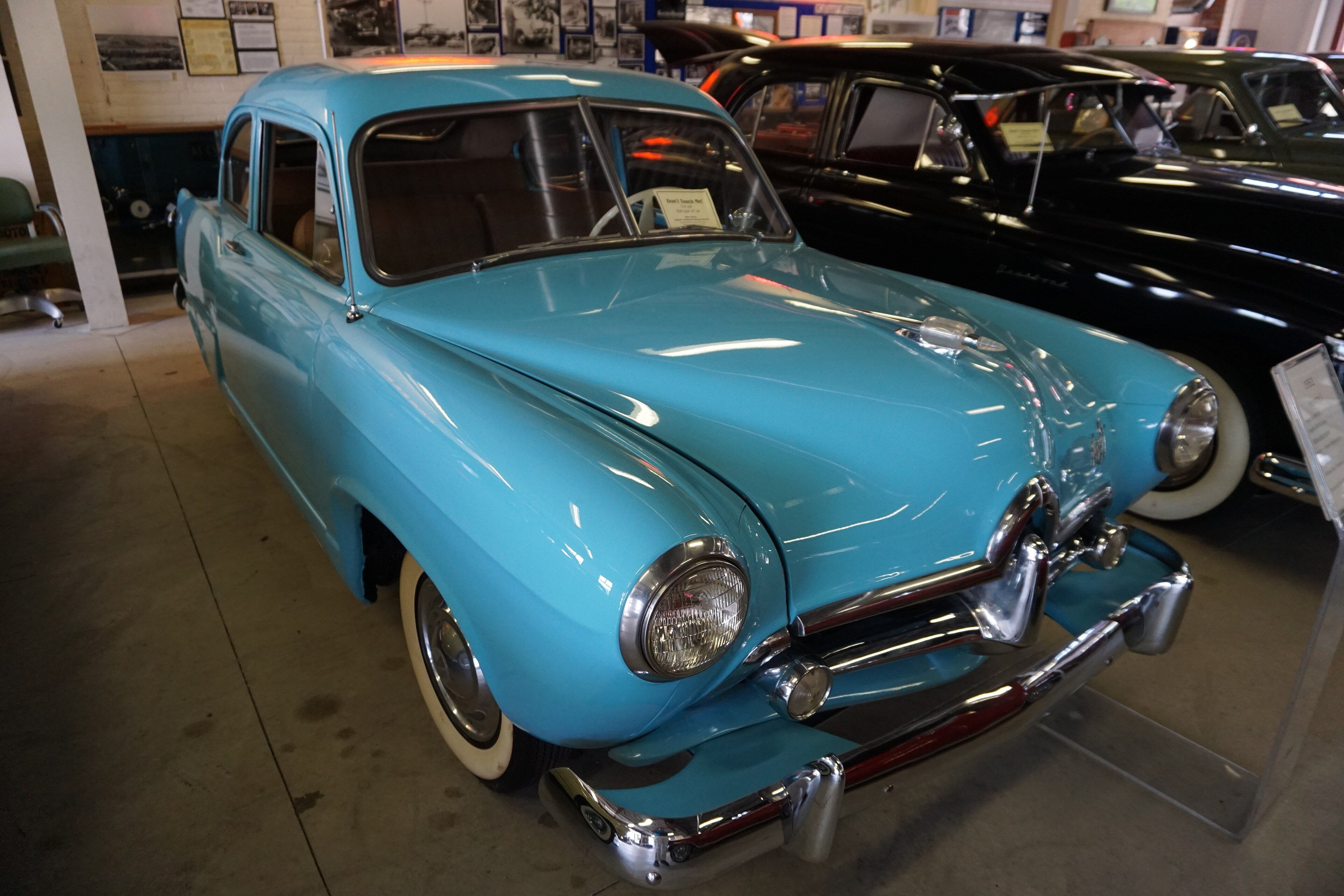 Light blue 1951 Henry J two-door sedan on museum display, front three-quarter view